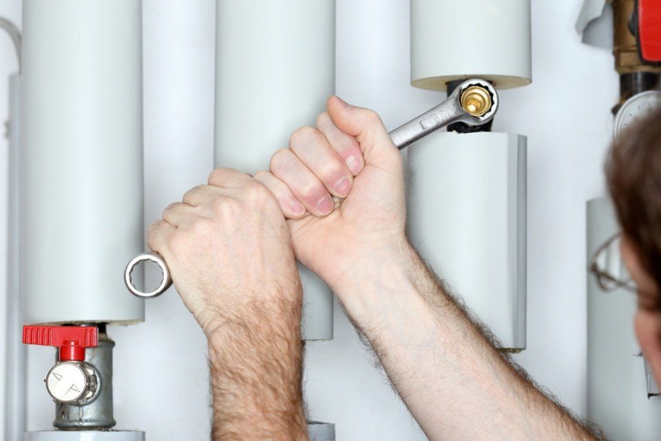 Close-up of plumber providing a service