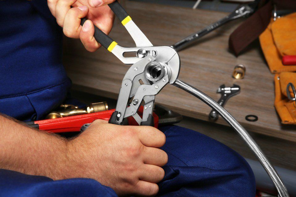 Close-up of a Gas Safe Registered engineer providing a plumbing service