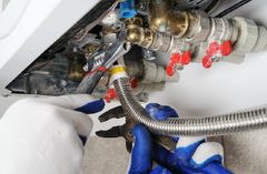 A close-up of employee maintaining gas appliance