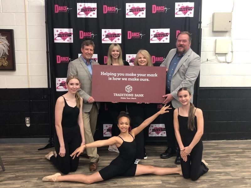 Traditions Bank presenting an EITC donation check