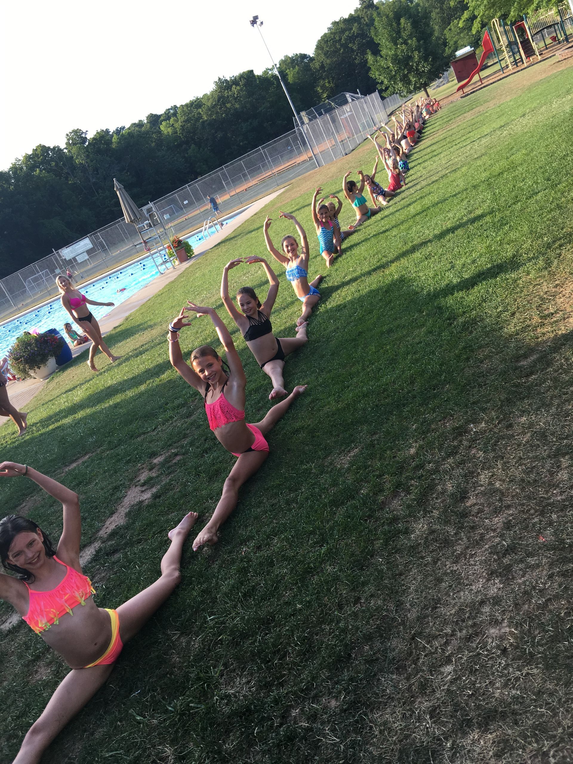 Company dancers doing splits at the pool