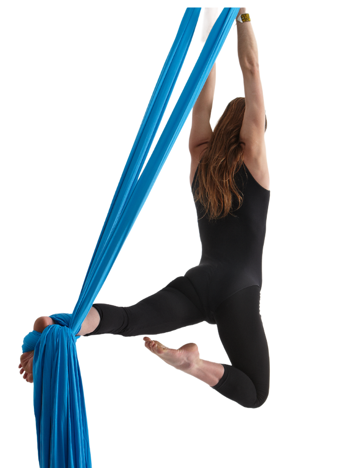 Woman in black activewear performing aerial silks with blue fabric. She is suspended mid-air, extending her arms overhead.