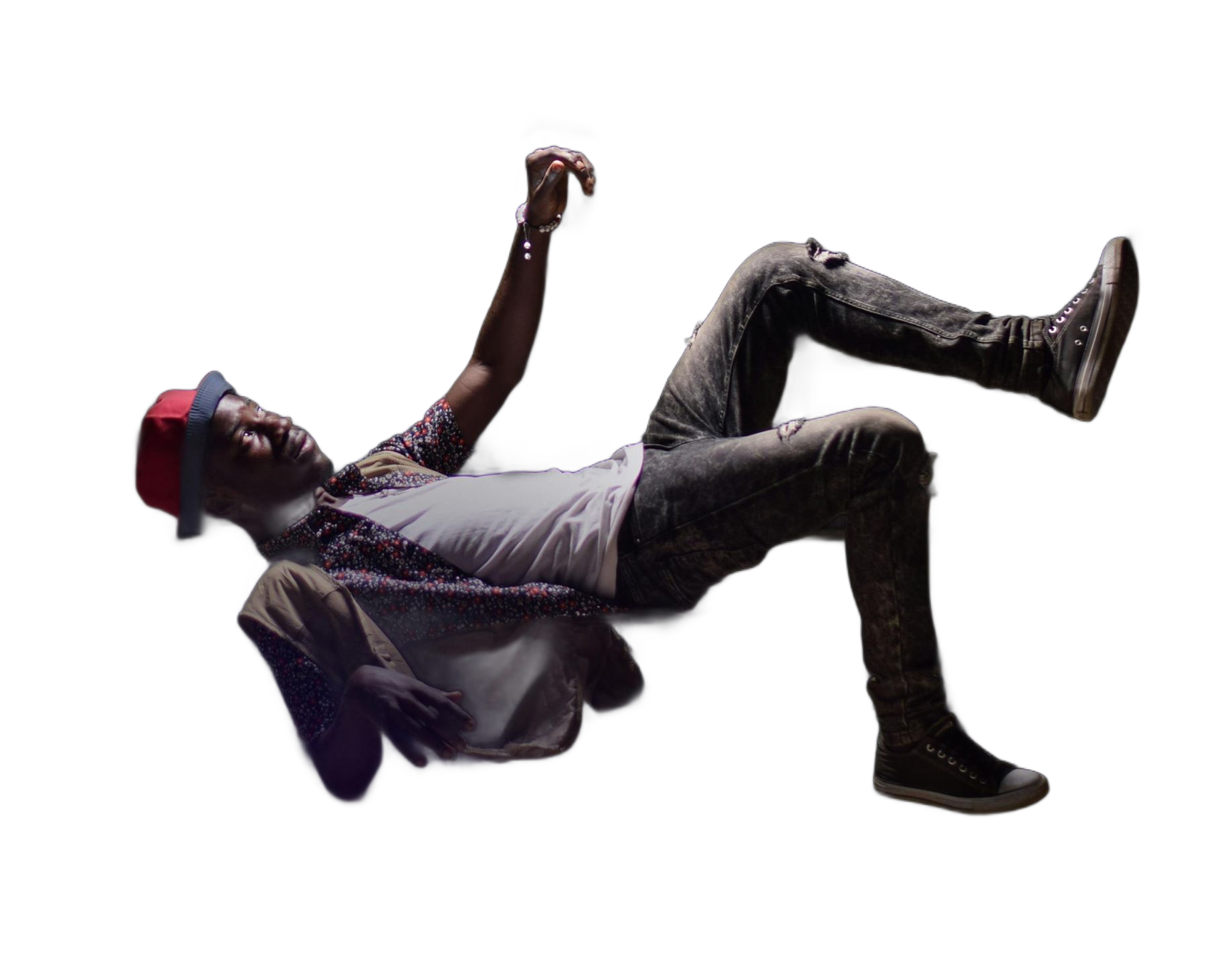 Man floating in the dark, wearing jeans, white shirt, and red cap, with a raised fist and relaxed expression.