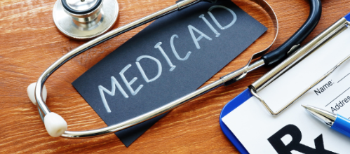 Stethoscope, prescription pad, and a sign reading