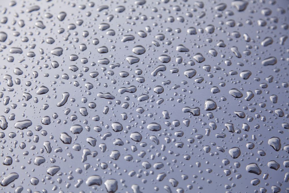 Water Droplets on a Shiny, Silver Surface, Reflecting Light — TrueGloss Elite Coatings In Wyong, NSW