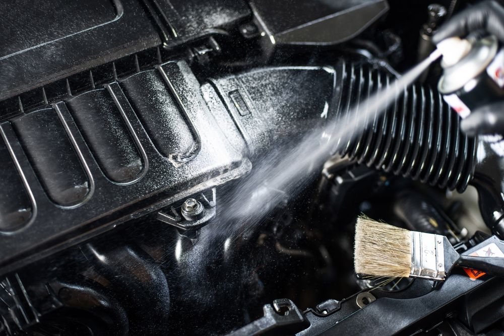 Spraying Fluid Onto Black Car Engine Parts; Brush Visible — TrueGloss Elite Coatings In Wyong, NSW