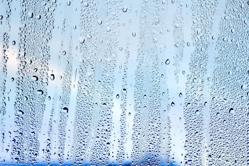 Water Droplets on a Window, Streaks of Condensation, Blue and White Background — TrueGloss Elite Coatings In Wyong, NSW