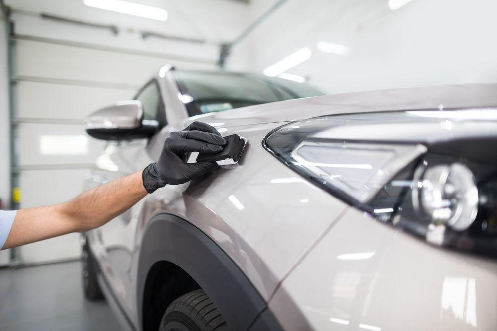 Person in Black Gloves Applying Ceramic Coating to a Beige Car's Front Fender — TrueGloss Elite Coatings In Wyong, NSW