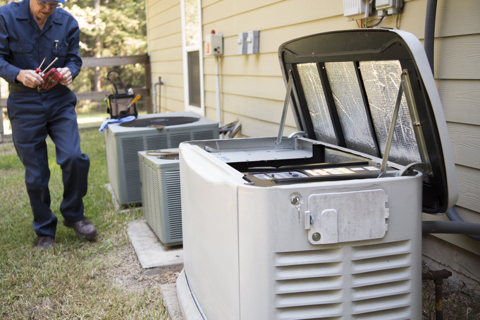 Technician Fixing Generator and AC Units — Jay, FL — Wingate Electrical Services