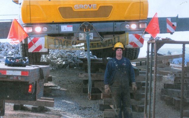 Leo Castonguay Standing Near a 120T Crane