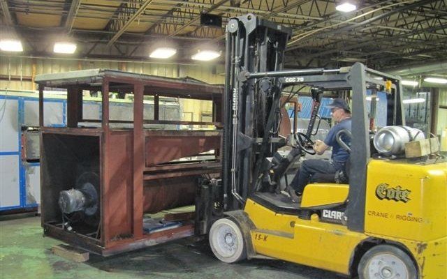 Forklift Operator Transporting Oven Section For Textile Product