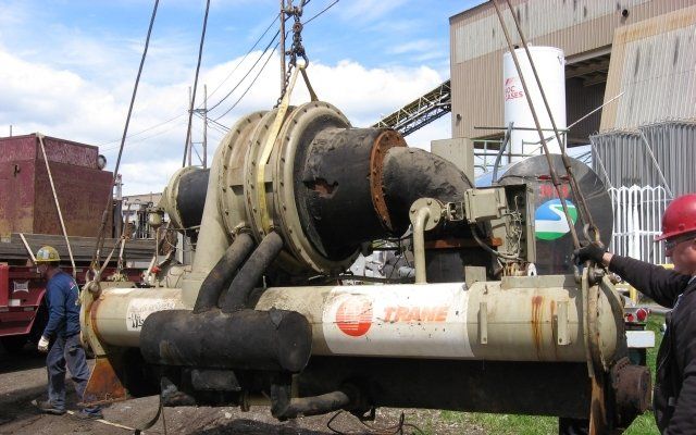 Chiller Being Hoisted into a Tractor