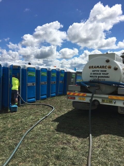 Worker Cleaning Portable Toilets — Septic Tank Cleaning in Armidale, NSW