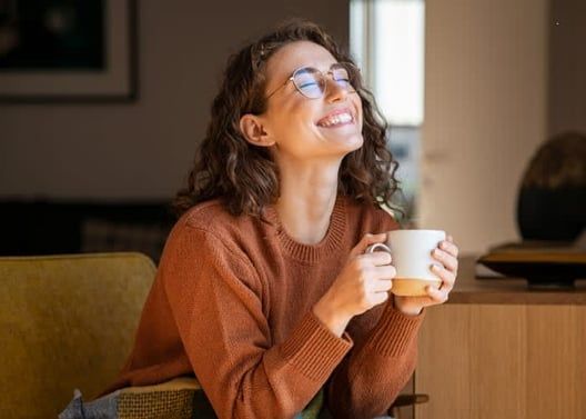 Happy woman holding coffee