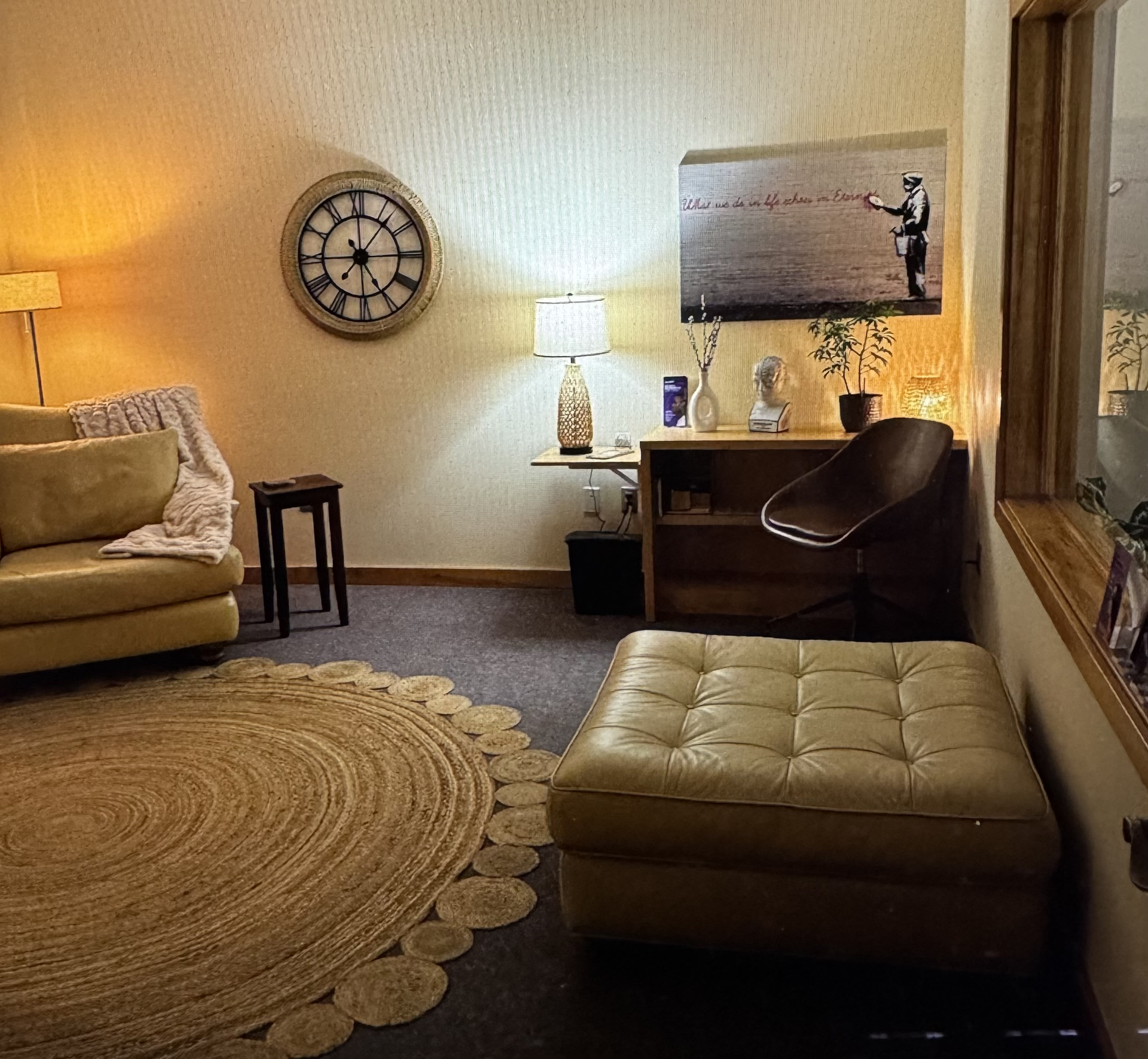 A doctor in a white coat reviews a tablet with a seated patient in an exam room. Both are focused on the tablet.