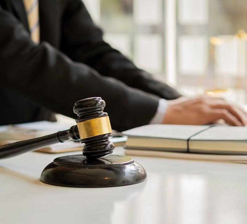 Lawyer using laptop and gavel