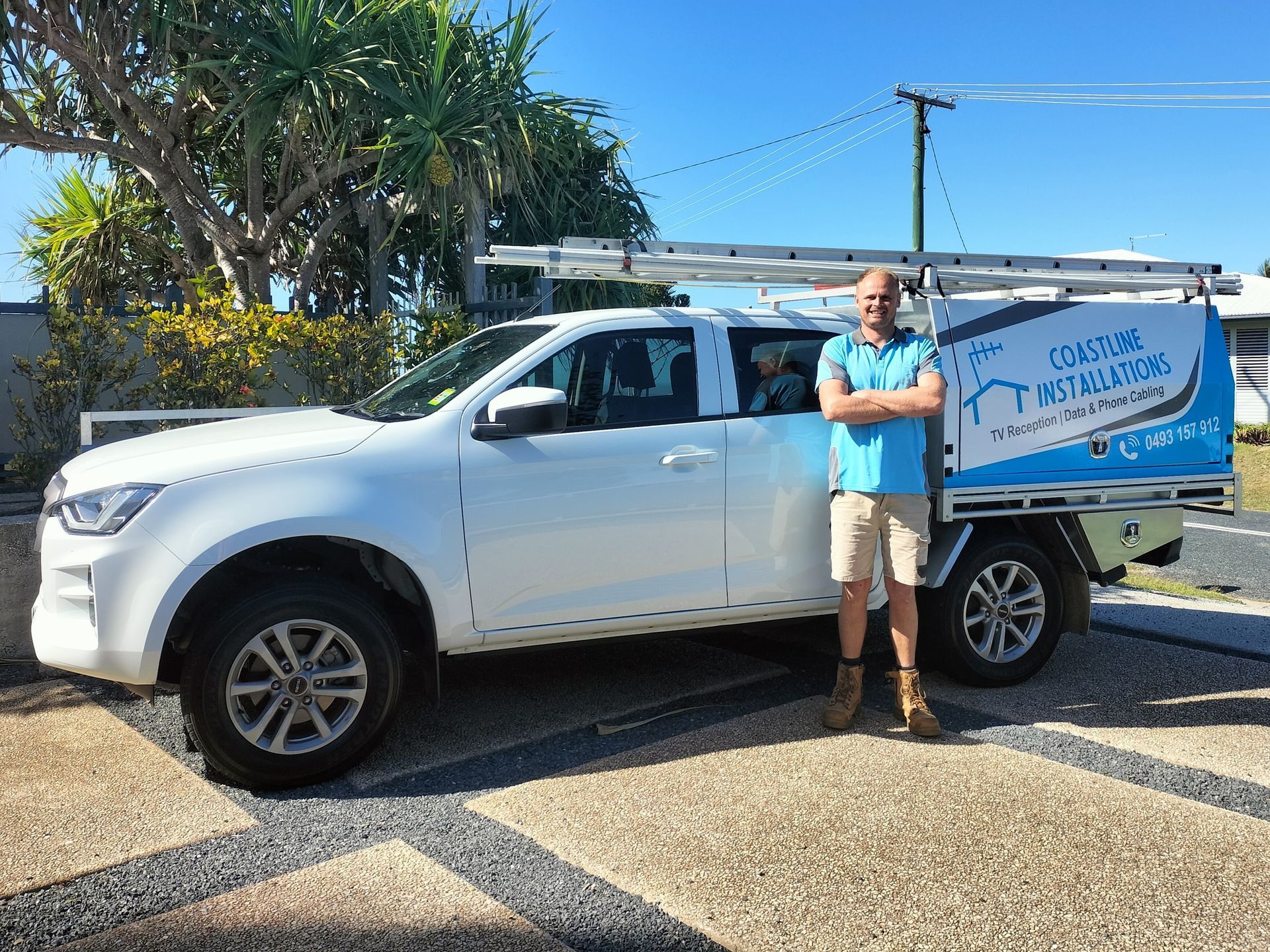 Worker Standing Beside His Work Ute — Coastline Installations In Emu Park, QLD