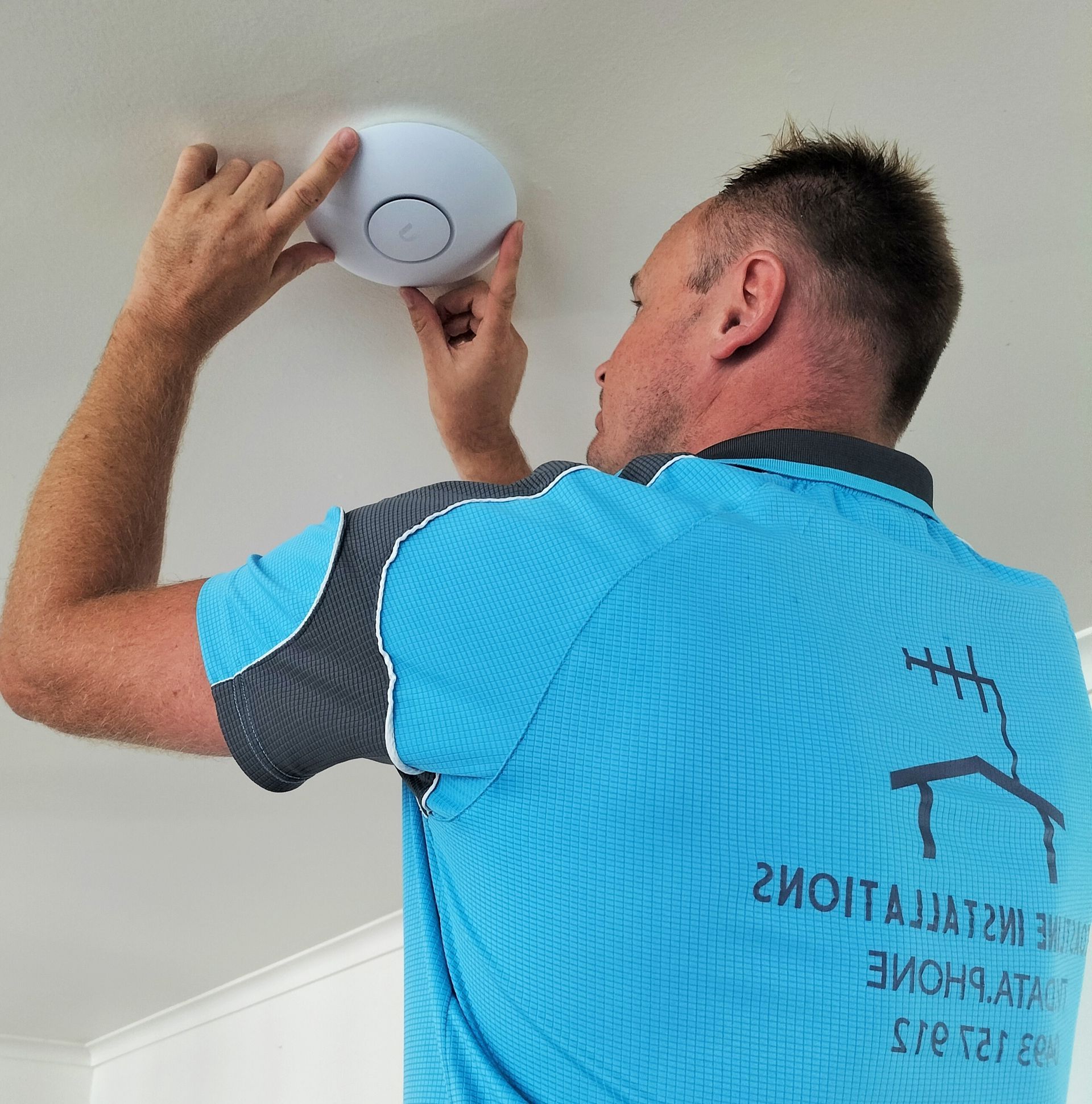 Electrician Installing Wifi Hub — Coastline Installations In Emu Park, QLD