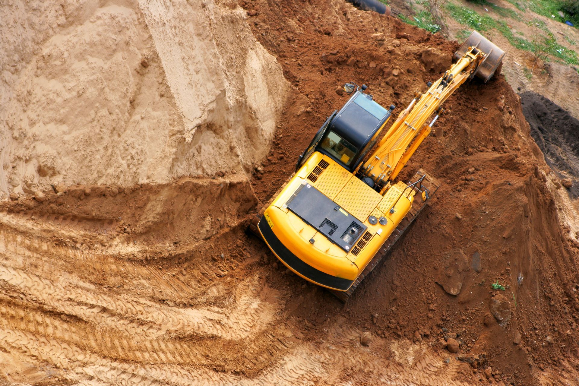 A person is laying pipes in a trench.