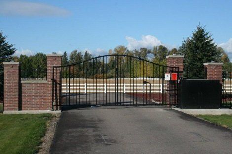 A metal gate with a brick wall behind it