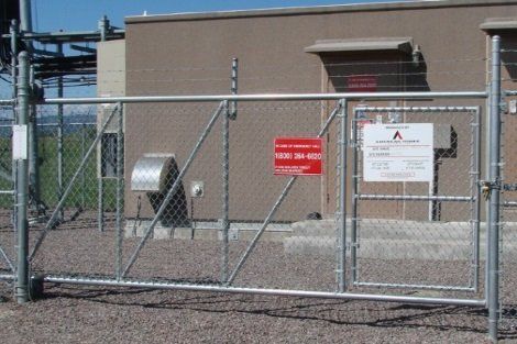 A chain link fence with a red sign that says no entry