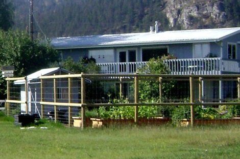 A large house with a wooden fence in front of it