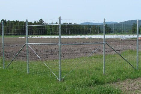 There is a fence in the middle of a field.