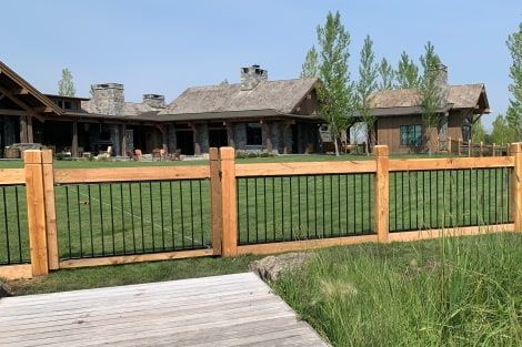 A large house with a wooden fence in front of it.