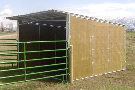 A shed with a fence around it in a field.