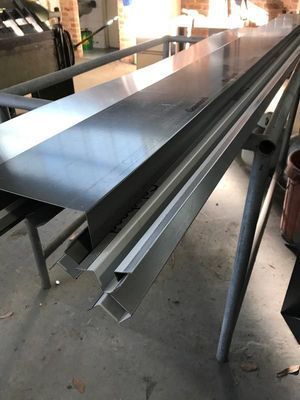 Long, Silver Metal Guttering on a Metal Frame in a Workshop — R&M Sheetmetal Nowra Metal Roofing in South Nowra, NSW