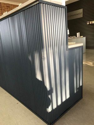 Blue Corrugated Metal Reception Desk With a White Countertop — R&M Sheetmetal Nowra Metal Roofing in South Nowra, NSW