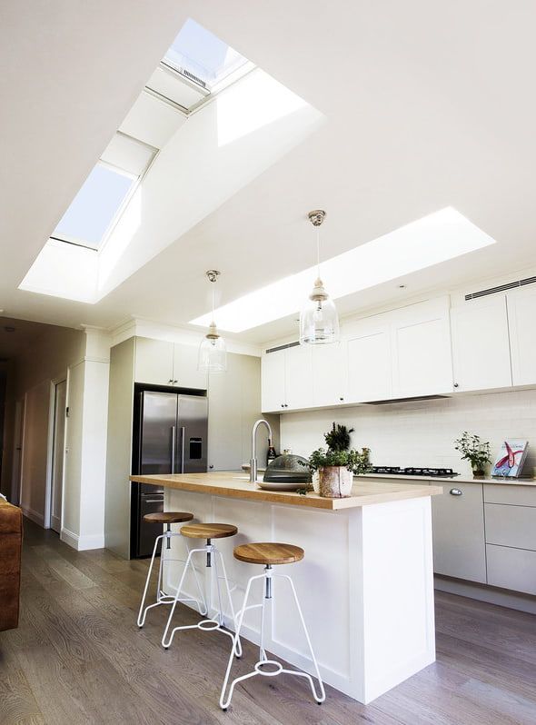 A Kitchen with White Cabinets and Stools — R&M Sheetmetal Nowra Metal Roofing in Kangaroo Valley, NSW