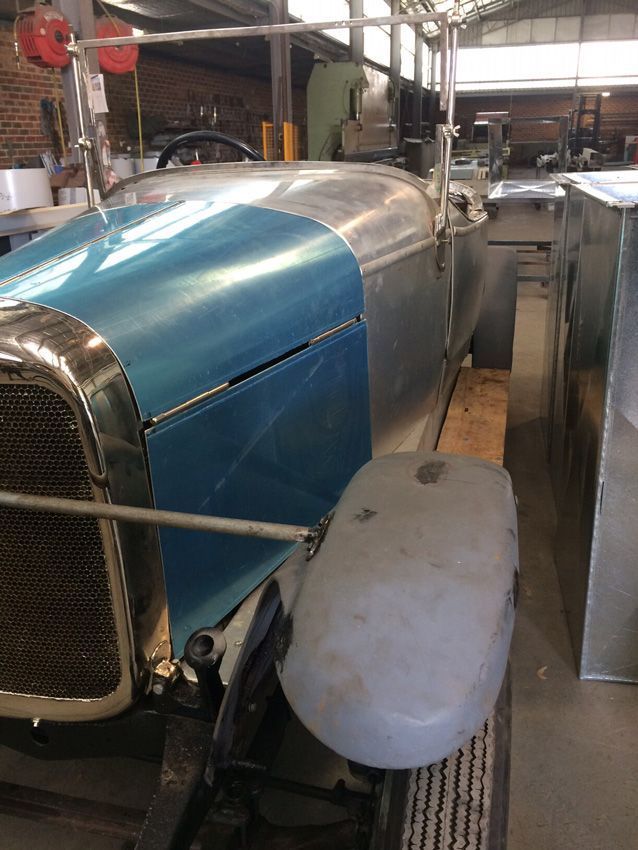 A Silver Car with A Blue Hood Is Parked in A Garage — R&M Sheetmetal Nowra Metal Roofing in South Nowra, NSW