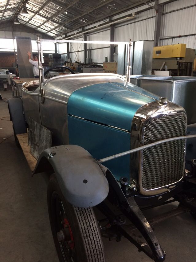 An Old Car with A Blue Hood Is Sitting in A Warehouse — R&M Sheetmetal Nowra Metal Roofing in South Nowra, NSW