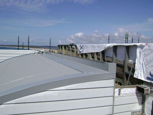 Construction Site With Curved Metal Roof — R&M Sheetmetal Nowra Metal Roofing in South Nowra, NSW