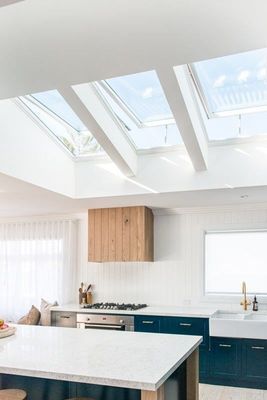Kitchen With Blue Cabinets, Skylights, Wooden Hood — R&M Sheetmetal Nowra Metal Roofing in South Nowra, NSW