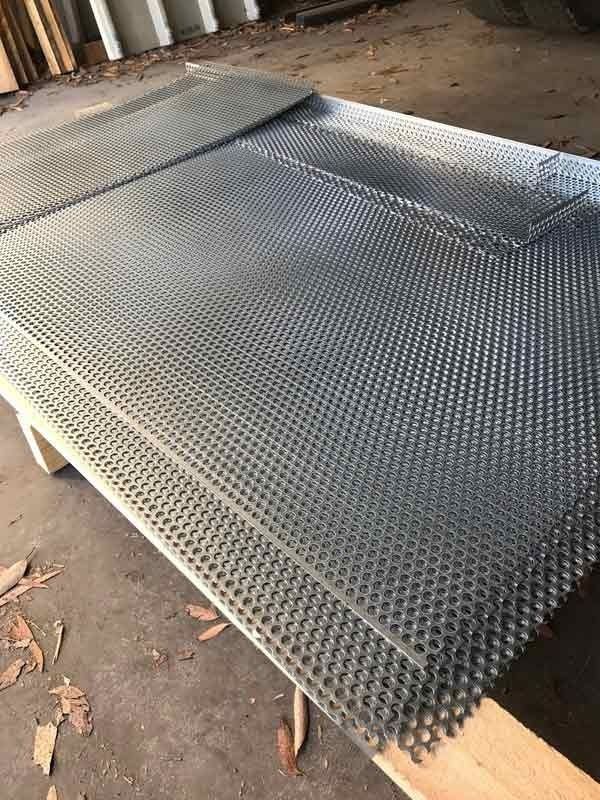 A Piece of Metal Is Sitting on Top of A Wooden Pallet — R&M Sheetmetal Nowra Metal Roofing in Kangaroo Valley, NSW