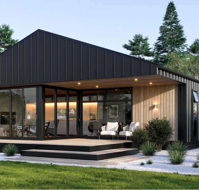 A Small House With a Black Roof and Lots of Windows — R&M Sheetmetal Nowra Metal Roofing in Culburra, NSW