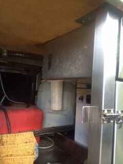A Stainless Steel Refrigerator Is Sitting Under a Table in A Kitchen — R&M Sheetmetal Nowra Metal Roofing in South Nowra, NSW