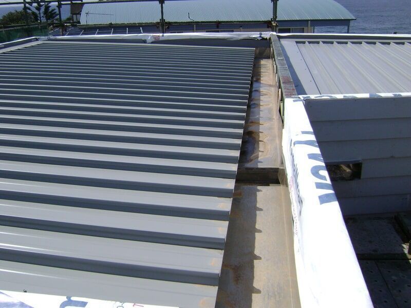 A Building with A Roof that Has a Drain on It — R&M Sheetmetal Nowra Metal Roofing in South Nowra, NSW