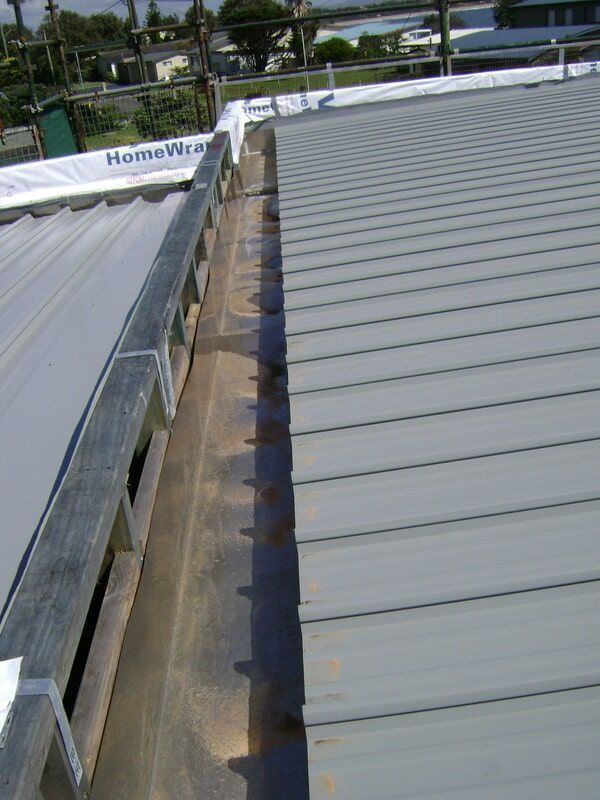 A Gutter on The Roof of A Building — R&M Sheetmetal Nowra Metal Roofing in South Nowra, NSW