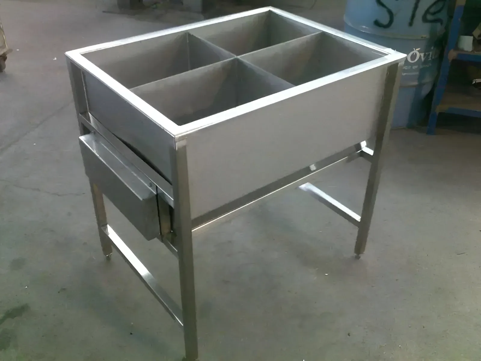 A stainless steel table with four compartments and a drawer underneath — R&M Sheetmetal Nowra Metal Roofing in South Nowra, NSW