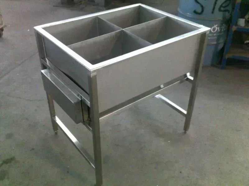 A stainless steel sink with four compartments and a drawer underneath it — R&M Sheetmetal Nowra Metal Roofing in Culburra, NSW