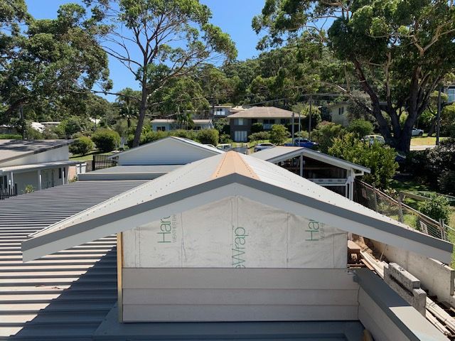A House with A Roof that Has a Roof Wrap on It and Trees in The Background — R&M Sheetmetal Nowra Metal Roofing in South Nowra, NSW