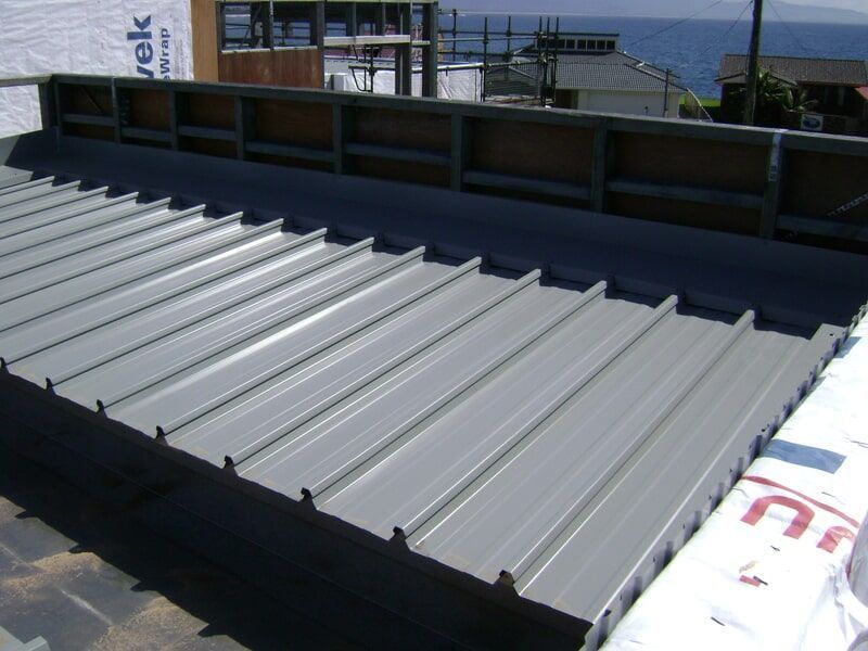 A Metal Roof Is Being Installed on A Building — R&M Sheetmetal Nowra Metal Roofing in Gerringong, NSW