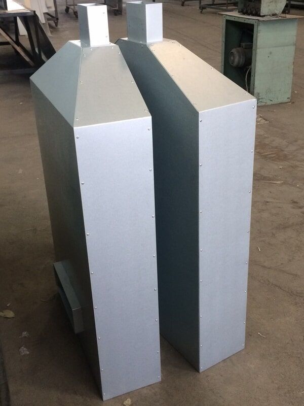 Two Metal Boxes Are Sitting Next to Each Other on The Floor — R&M Sheetmetal Nowra Metal Roofing in South Nowra, NSW