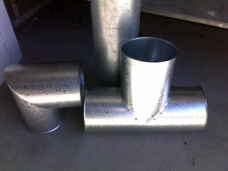 Three Metal Pipes Are Stacked on Top of Each Other — R&M Sheetmetal Nowra Metal Roofing in South Nowra, NSW