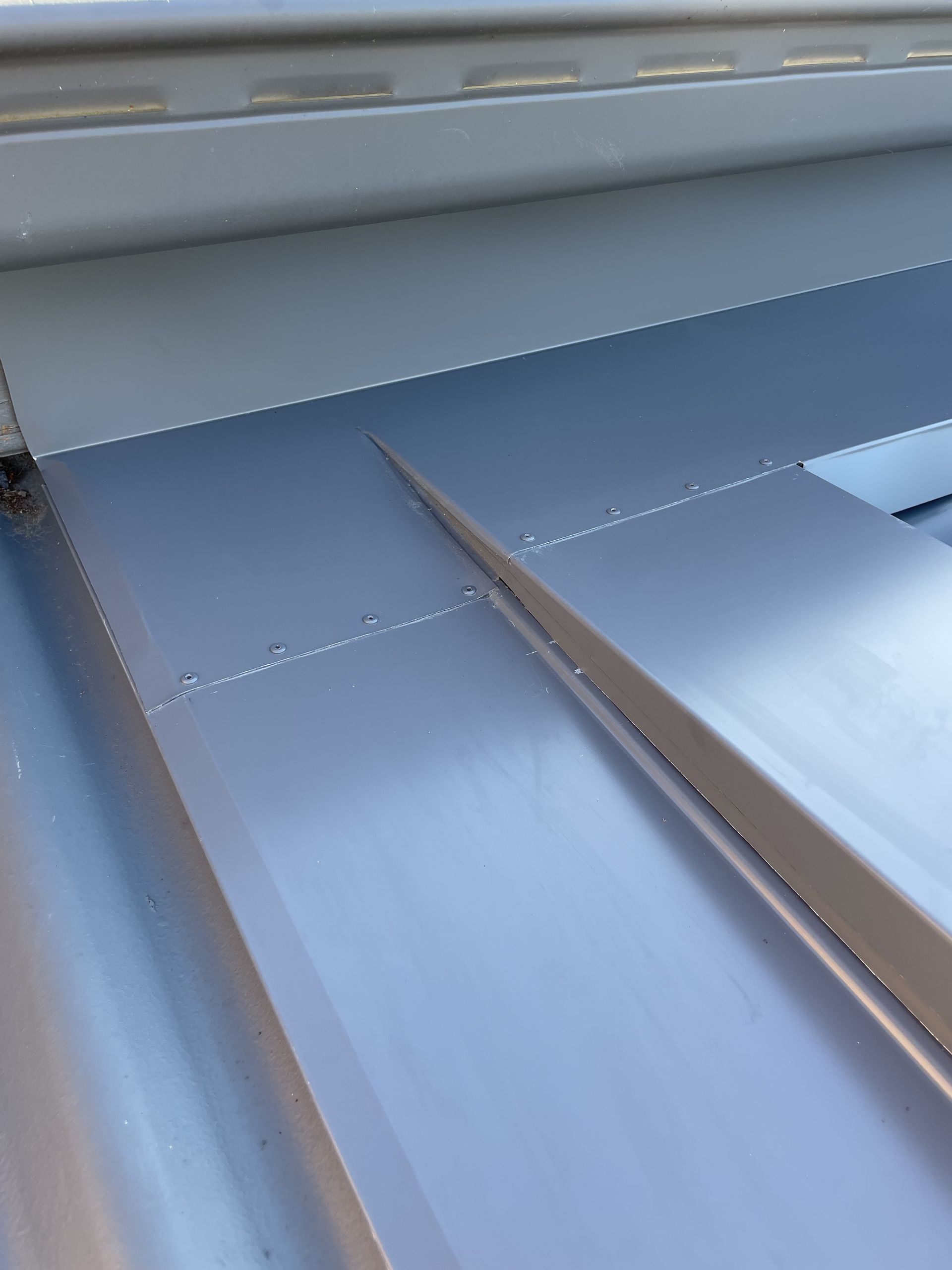 Close-up of a silver metal roof with a seam, showing a detailed construction. — R&M Sheetmetal Nowra Metal Roofing in South Nowra, NSW