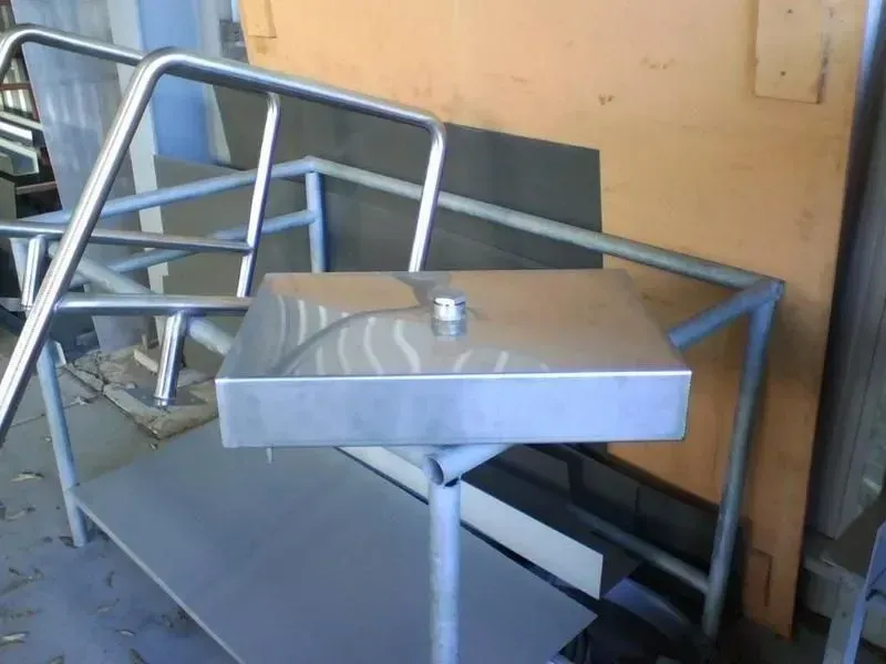 Stainless steel rectangular box on a metal stand, near a metal railing structure. — R&M Sheetmetal Nowra Metal Roofing in South Nowra, NSW