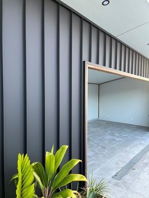 There Is a Plant in Front of A Metal Wall Building — R&M Sheetmetal Nowra Metal Roofing in South Nowra, NSW